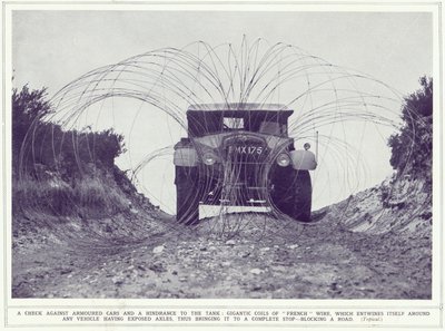 An armoured car is stopped by gigantic coils of French wire blocking the road, from The Illustrated War News, published 22nd November 1939 by English Photographer
